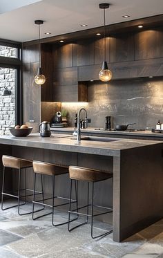 a kitchen with an island and bar stools in front of the countertop area