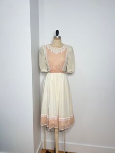 Vintage 1970s Gunne Sax 3/4 sleeve prairie cottagecore midi dress with lace neckline & bust, button down closure in the back & detachable belt. This gorgeous dress has puff shoulder sleeves and is lined. Gunne Sax 7 B: 34" W: 26" to 30" L: 46" Vintage Midi Dress With Lace Trim For Spring, Spring Vintage Midi Dress With Lace Trim, Vintage Dresses With Lace Patchwork For Daywear, Vintage Beige Prairie Dress For Summer, Vintage Lace Midi Dress, Cottagecore Vintage Midi Dress For Garden Party, Vintage Midi Dress With Lace Trim For Garden Party, Retro Vintage White Dress For Spring, Vintage Lace Trim Midi Dress For Spring