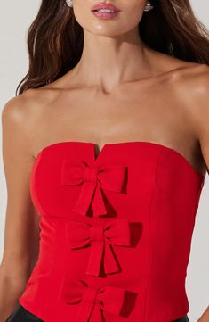 Turn on the charm in this sleek strapless crop top sweetened by a trio of darling bows. 13" center front length (size Medium) Side zip closure Strapless Lined 95% polyester, 5% elastane Dry clean Imported Bodycon Dress Winter, Black Tie Bridesmaids, Strapless Sheath Dress, Senior Party, College Gameday Outfits, Layered Bow, Birthday 25, Bow Mini Dress, Going Out Clothes