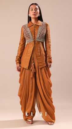 Experience the splendor of our copper brown kurta and palazzo set.
The jacket is detailed with cutdana and sequins.
This set is made from crepe tussar fabric.
This outfit is ideal for mehendi and sangeet events.
The kurta is coupled with a jacket and dhoti. Desi Attire, Kurta And Palazzo, Ethnic Dresses, Coord Sets, Dress Models, Traditional Indian Dress, Kurti Embroidery Design, Saree Blouse Patterns, Bottom Design