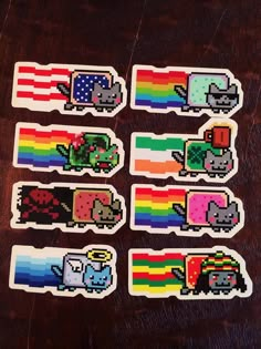 six stickers with different colored animals and rainbows on them sitting on a table