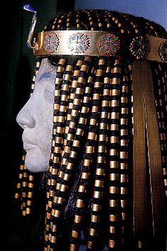 an elaborate headdress with gold and black beads