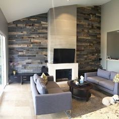 a living room filled with furniture and a flat screen tv mounted on the wall above a fireplace