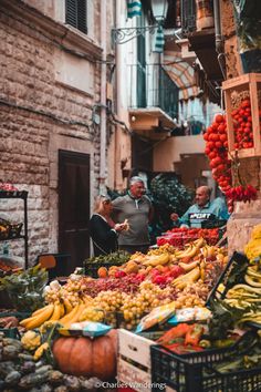 an outdoor market with lots of fruits and vegetables