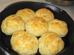 biscuits are cooking in a skillet on the stove