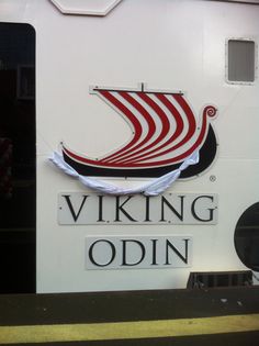 the viking logo is painted on the side of a ship's hull and it appears to be red, white, and black