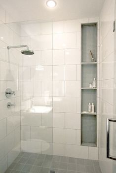 a bathroom with a shower and shelves on the wall