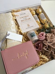 a pink purse and some items in a box