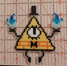 a piece of art made to look like a triangle with an eye and hat on it