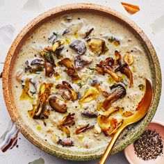 a bowl filled with soup next to a spoon