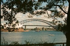 a boat is in the water near a bridge