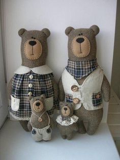 two teddy bears are dressed in plaid clothes and standing next to each other on a shelf