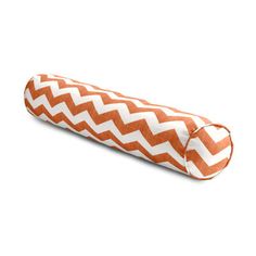 an orange and white zigzag pillow on a white background