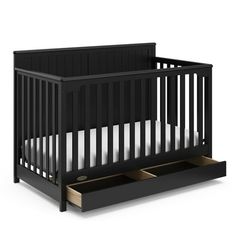 a black crib with two drawers on the bottom and an open drawer underneath it