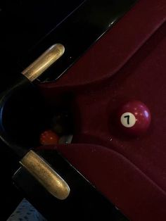 a pool table with two red balls and one white ball in the middle of it