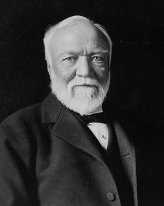 an old black and white photo of a man with a beard wearing a suit jacket