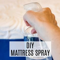 a hand holding a bottle with the words diy mattress spray on it