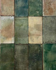 several different colored tiles are arranged in the shape of squares, with one green and two brown squares on each side