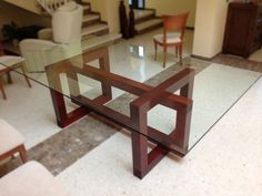 a glass table sitting on top of a checkered floor in front of a stair case