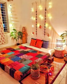 a room with a bed, potted plants and string lights