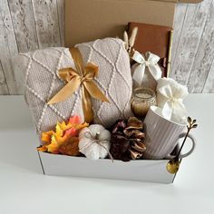 a gift box filled with coffee and fall leaves