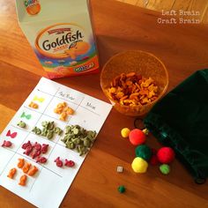 a table with cereal, gummy bears and a bag of goldfish crackers