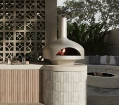 an outdoor kitchen with a pizza oven in the middle