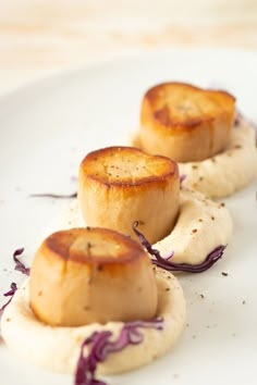 three pieces of food on a white plate