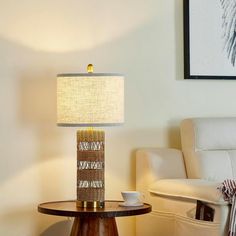 a table with a lamp on it next to a couch