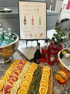 an assortment of drinks and snacks on a table with a sign in the background that says gin