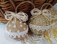 two decorative eggs are sitting next to each other on a doily covered tablecloth