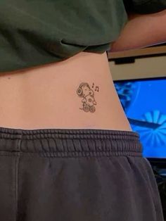 a person with a small tattoo on their stomach