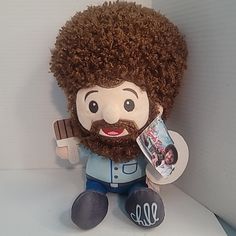 a stuffed toy with an afro holding a magazine