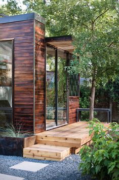 a small wooden house sitting in the middle of a forest