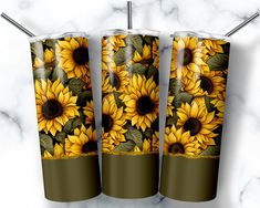 three yellow sunflowers with green leaves on a marble background, and two matching tumblers