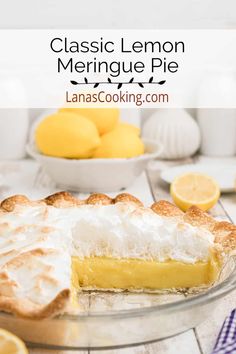 a lemon meringue pie on a table with lemons in the background and text overlay reading classic lemon meringue pie