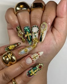 a woman's hand with many different colored nail polishes on it and gold rings