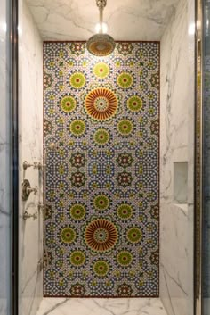 the shower is decorated with colorful tiles