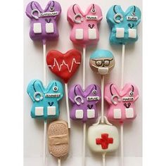 several medical themed lollipops are arranged on sticks