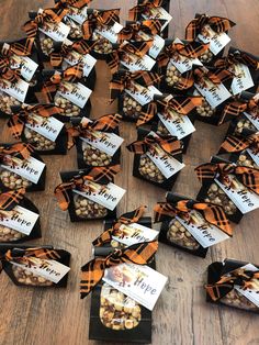 a table topped with lots of boxes filled with nuts next to each other on top of a wooden floor