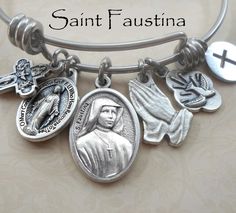 * The Personalization Box is for optional add-on charms only.  I have no engraving equipment.  However, you may purchase an add-on custom word charm, which you'll find in my shop.  Contact me if you need assistance.  Thank you * Saint Faustina Bangle Bracelet It features all the charms in the first two photos:  Finely Detailed Italian Made Charms: Saint Faustina with "Pray for Us' engraved on the reverse side, Miraculous Medal, Four Way Devotional Catholic Cross, Holy Spirit Charm, Hands in Pray Saint Rita Of Cascia, Rita Of Cascia, Mermaid Locket, Saint Rita, St Rita Of Cascia, Anthony Of Padua, Catholic Cross, Wire Bangle Bracelets, Silver Gift Box