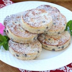 some powdered sugar cookies on a white plate