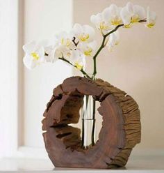 a vase with white flowers in it sitting on a table next to a window sill