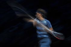 a blurry image of a man holding a tennis racquet