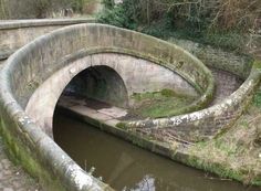 an old stone bridge over a small river