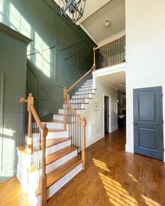 a staircase in an empty house with wood floors