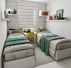 two beds sitting next to each other in a room with white walls and flooring