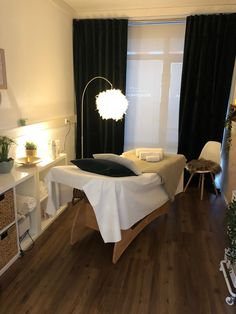 a bed room with a neatly made bed next to a window