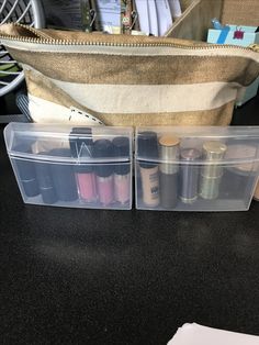 two clear plastic containers filled with different types of sewing thread in front of a canvas bag