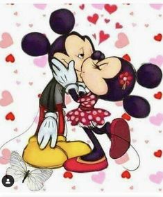 mickey and minnie kissing each other with hearts in the background